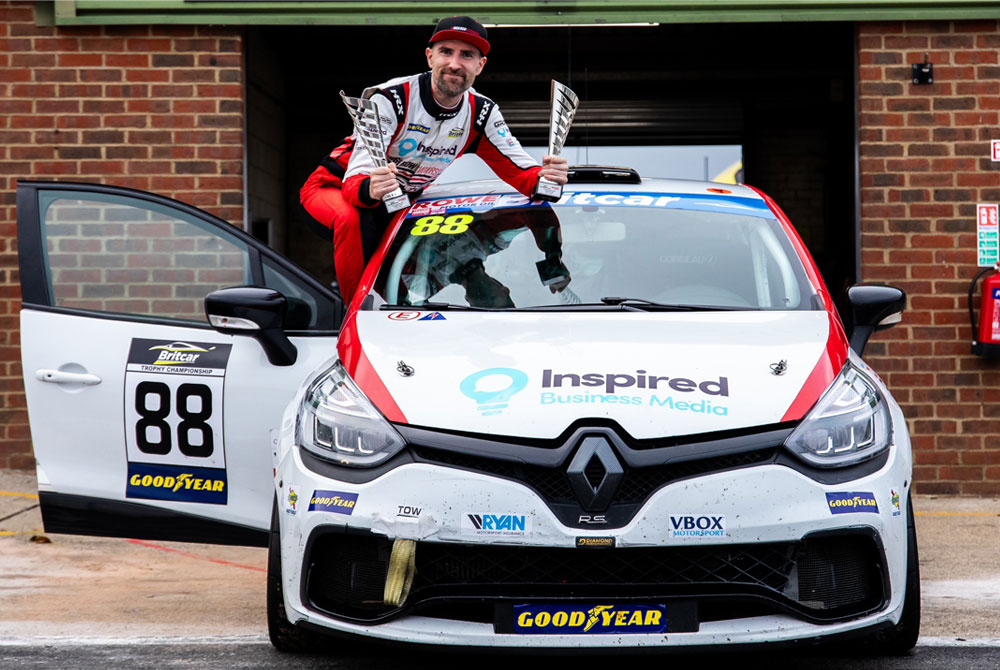 Man stood on car celebrating race wins