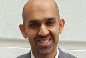 Asian man wear working suit and standing back the wall