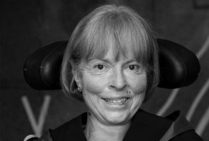 An image of Baroness Jane Campbell. she wears robes and has is seated in her powered chair.