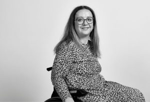 A dark haired woman wearing a leopard print dress